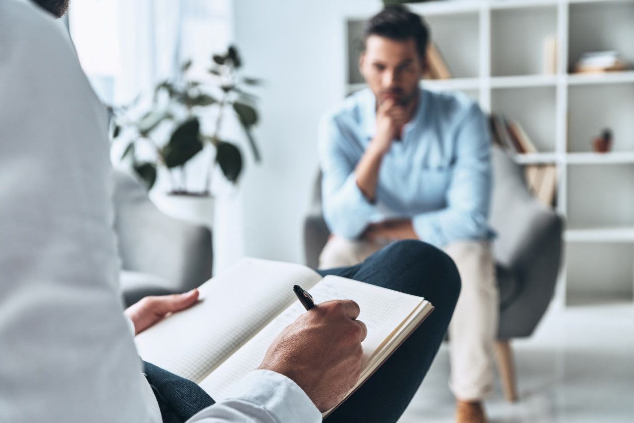 man consulting a therapist